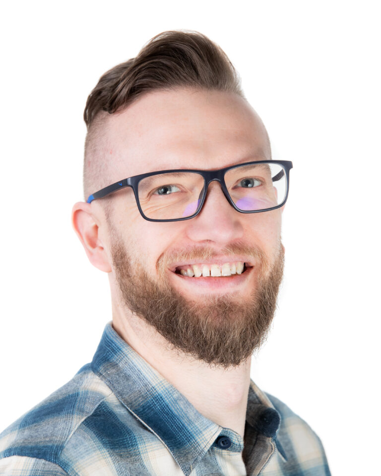 bearded man wearing glasses and smiling